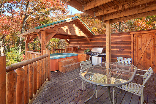 Dining on the covered deck at Hidden Pleasure, a 1-bedroom cabin rental located in Gatlinburg