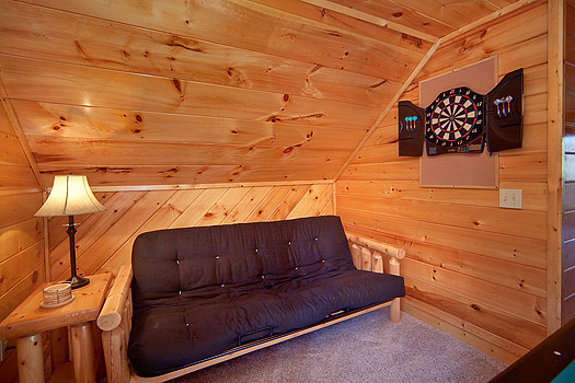 Futon in the game room at Hidden Pleasure, a 1-bedroom cabin rental located in Gatlinburg