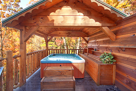 Hot tub on a covered deck at Hidden Pleasure, a 1-bedroom cabin rental located in Gatlinburg