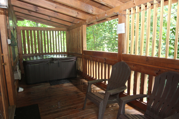 Hot tub on a deck with privacy fencing at Honeymoon in Gatlinburg, a 1 bedroom cabin rental located in Gatlinburg