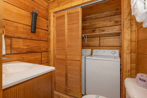 Washer and dryer in a bathroom at Honeymoon in Gatlinburg, a 1 bedroom cabin rental located in Gatlinburg