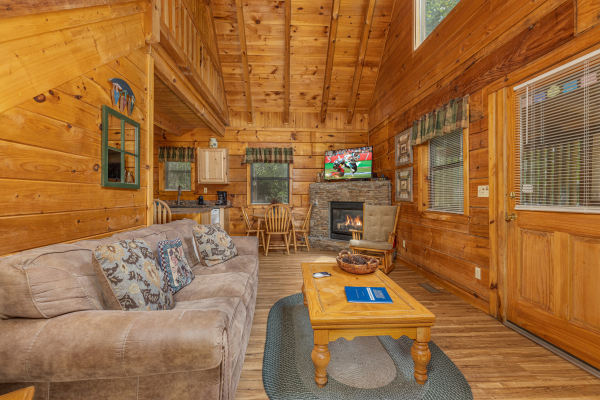 Living room with TV and fireplace at Honeymoon in Gatlinburg, a 1 bedroom cabin rental located in Gatlinburg