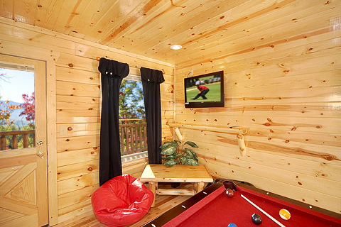 Deck access from game room at Natural Wonder, a 4 bedroom cabin rental located in Gatlinburg
