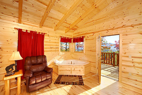 Jacuzzi tub and recliner at Natural Wonder, a 4 bedroom cabin rental located in Gatlinburg