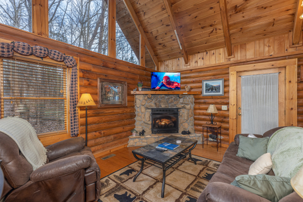 Living room with a fireplace and TV at A Lover's Secret, a 1 bedroom cabin rental located in Gatlinburg