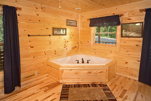 King bedroom with jacuzzi tub at Pool House, a 2 bedroom cabin rental located in Gatlinburg