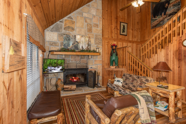 Living room with fireplace and TV at Papa Bear, a 3 bedroom cabin rental located in Pigeon Forge