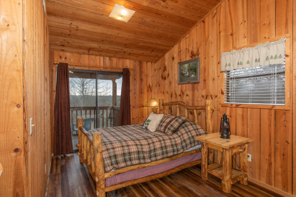 Bedroom in the loft with deck access at Papa Bear, a 3 bedroom cabin rental located in Pigeon Forge