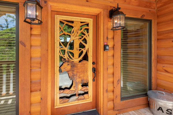 Elk carving in the front door at Elk Horn Lodge, a 5 bedroom cabin rental located in Gatlinburg