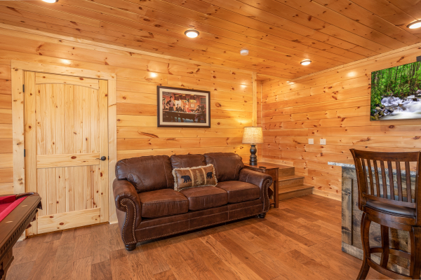 Sofa in the game room at Elk Horn Lodge, a 5 bedroom cabin rental located in Gatlinburg