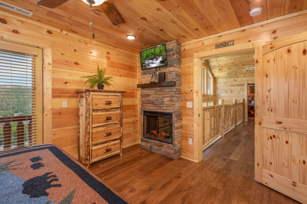 Fireplace and TV in a bedroom at Elk Horn Lodge, a 5 bedroom cabin rental located in Gatlinburg