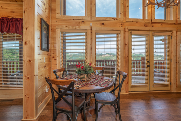 Dining table for four at Elk Horn Lodge, a 5 bedroom cabin rental located in Gatlinburg