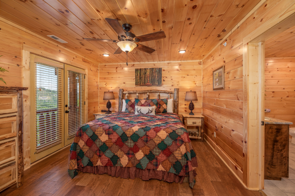 Bedroom with a king log bed at Elk Horn Lodge, a 5 bedroom cabin rental located in Gatlinburg