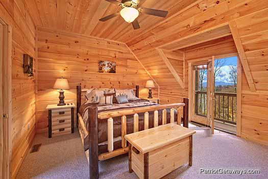 King sized bed in bedroom at Alpine Pointe, a 5 bedroom cabin rental located in Gatlinburg