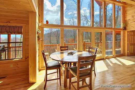 Seating for four around this bar height table in the living room at Alpine Pointe, a 5 bedroom cabin rental located in Gatlinburg