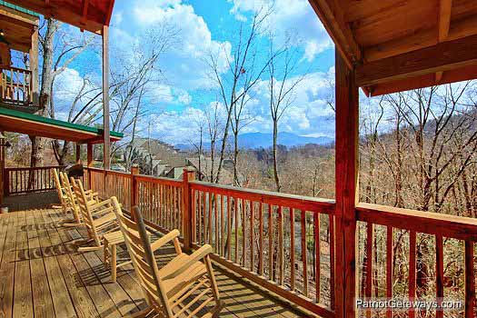 Four rocking chairs overlooking the Great Smoky Mountains at Alpine Pointe, a 5 bedroom cabin rental located in Gatlinburg