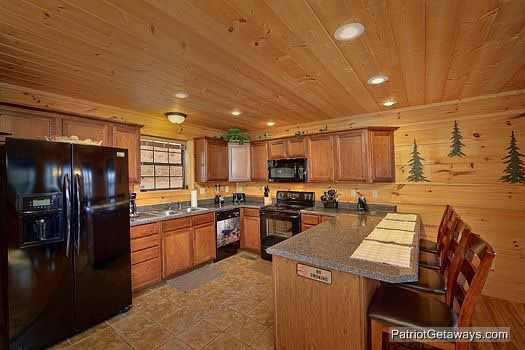 Kitchen with bar and barstools at Alpine Pointe, a 5 bedroom cabin rental located in Gatlinburg