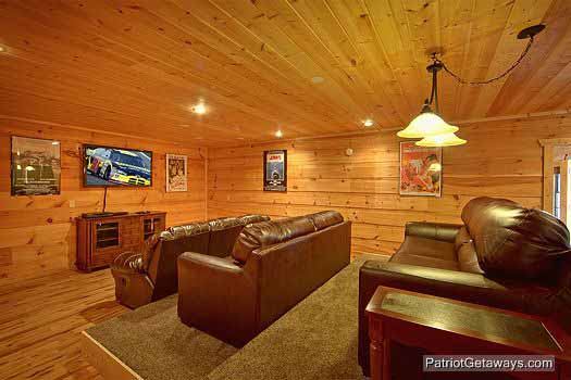 A large theater room with sofa stadium seating to enjoy your favorite at Alpine Pointe, a 5 bedroom cabin rental located in Gatlinburg