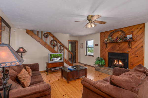 Fireplace with a wooded surround in the living room at Black Bear Ridge, a 3-bedroom cabin rental located in Pigeon Forge