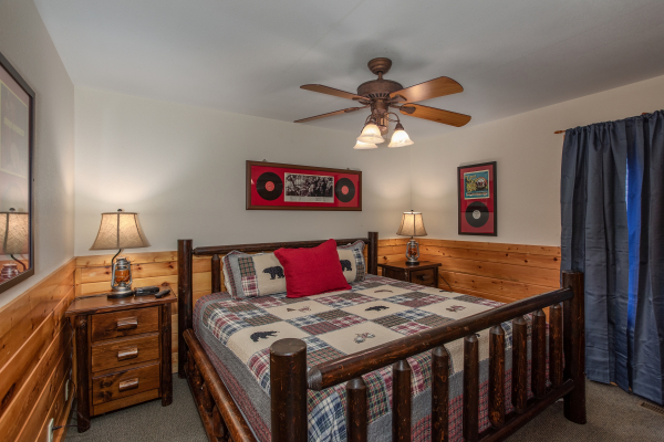 Bedroom with log bed and two night stands at Mountain Music, a 5 bedroom cabin rental located in Pigeon Forge