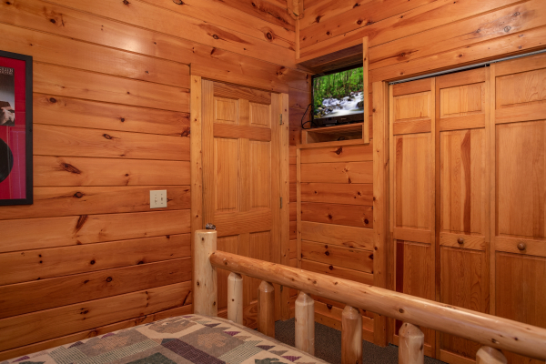 TV and closet in a bedroom at Mountain Music, a 5 bedroom cabin rental located in Pigeon Forge
