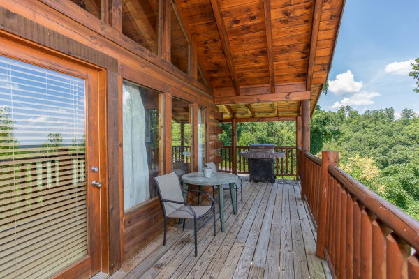 Covered deck seating for two at Majestic Sunrise, a 1 bedroom cabin rental located in Pigeon Forge