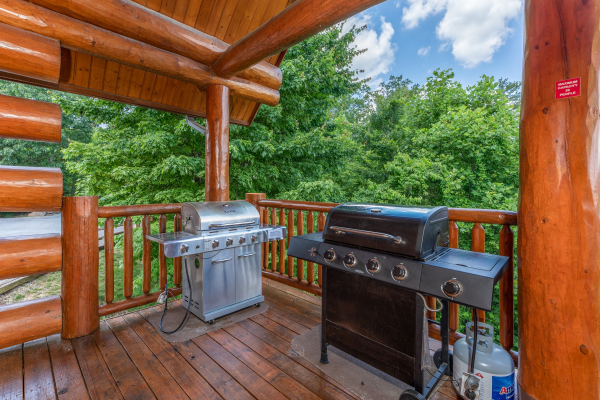 Two propane grills on a covered deck at God's Country, a 4 bedroom cabin rental located in Pigeon Forge