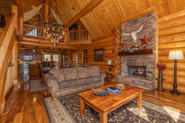Sofa and fireplace in the living room at God's Country, a 4 bedroom cabin rental located in Pigeon Forge