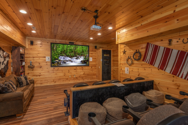 Theater room with a large screen at God's Country, a 4 bedroom cabin rental located in Pigeon Forge