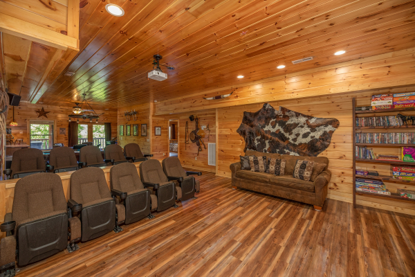 Theater room with sofa and theater seating at God's Country, a 4 bedroom cabin rental located in Pigeon Forge