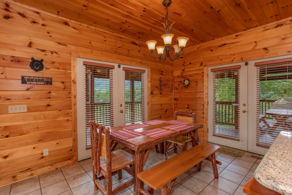 Dining space with seating for six at Four Seasons Lodge, a 3-bedroom cabin rental located in Pigeon Forge