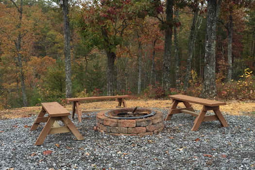 Fire pit with bench seats at at Four Seasons Lodge, a 3-bedroom cabin rental located in Pigeon Forge