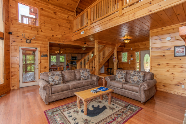 Sofa and loveseat in the living room at Four Seasons Lodge, a 3-bedroom cabin rental located in Pigeon Forge