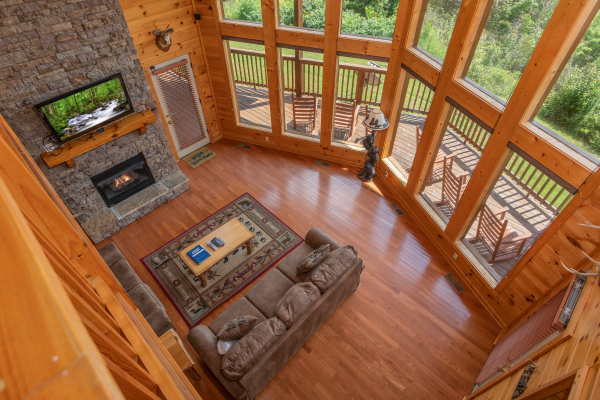 Looking down into the living room from the upper floor at Four Seasons Lodge, a 3-bedroom cabin rental located in Pigeon Forge