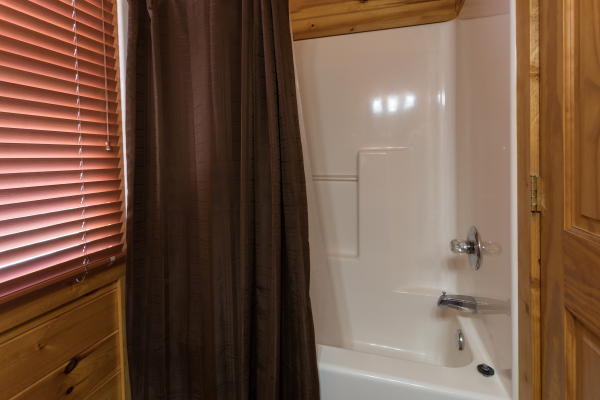 Upstairs bath with a tub and shower at Four Seasons Lodge, a 3-bedroom cabin rental located in Pigeon Forge